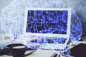 Businessman with computer background with brain theme hologram. Concept of brainstorm. Multi exposure.