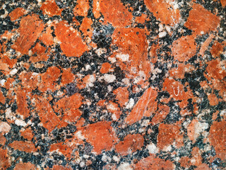 Fototapeta premium Grunge background from red granite natural stone texture. Polished surface, copy space.
