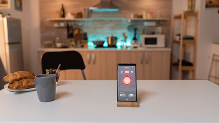 Close up smartphone with active smart home application. Phone with touching screen late at night...