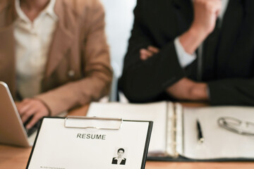Examiner reading a resume during job interview at office Business and human resources concept