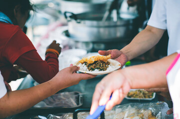 Volunteers give away free charity food to the poor : concept of sharing