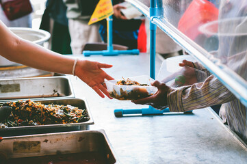 Volunteers give away free charity food to the poor : concept of sharing