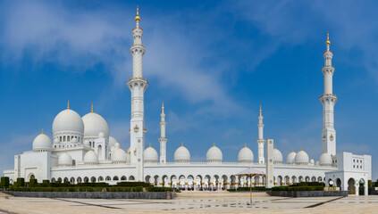 White Grand Mosque against blue sky, also called Sheikh Zayed BinSultan Nahyan Mosque, inspired by Persian, Mughal and Moorish mosque architecture, in Abu Dhabi, UAE