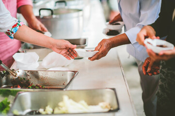 Poverty concept : Feeding food to the poor