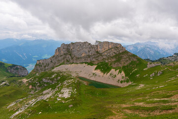 summer mountains green grass and blue sky landscape near achensee in austria, europe alps in cloudy day