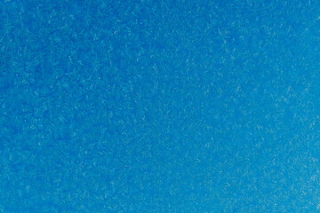 Obraz na płótnie Canvas blue frost on a glass background. texture patterned frosted glass.