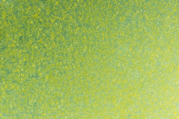 yellow frost on a glass background. texture patterned frosted glass.