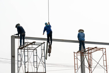 Naklejka premium Construction Scaffolding Worker conect the steel beam by gas welding equipment