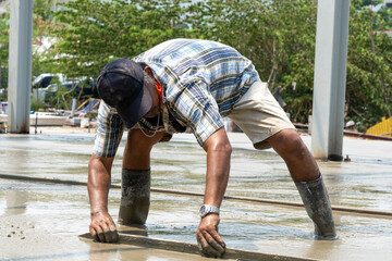 Concreteer adjusting the concrete floor.