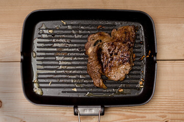 Freshly roasted meat in frying pan
