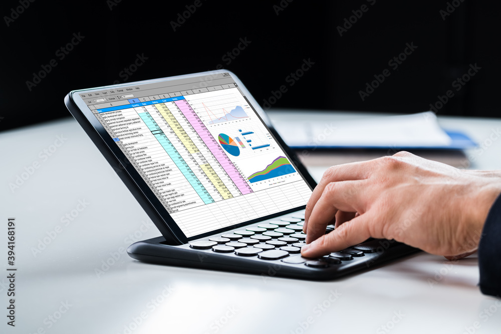 Poster Analyst Using Spreadsheet Report On Tablet