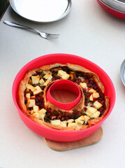 Still life with a red bowl with Homemade cheese and vegetables pie.  Eating and cooking dessert concept