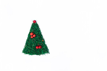 Christmas tree made of spruce needles, decorated with red rowan berries on white background.  Christmas, New Year minimalistic concept.