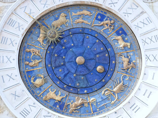 Beautiful sundial with a golden sun in Venice