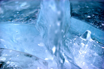 Blue blocks of ice close up with bubbles and cracks