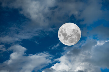 Naklejka na ściany i meble Full moon on the blue sky with clouds.