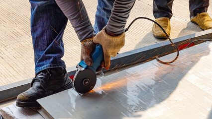Working man holding fiber cutting the steel plate,Building construction concept, Industry electric      