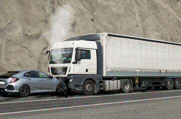 Frontal impact between a car and a truck. Car accident. Collision between a truck and a car