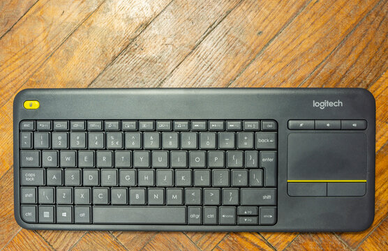 Niedomice, Poland - November 21, 2019: Logitech wireless keyboard on a wooden background.