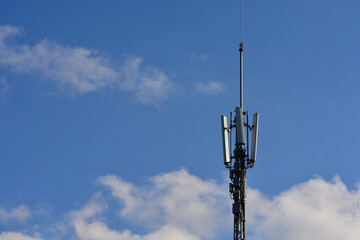 telecomunication transmission mast on blue background with space for text