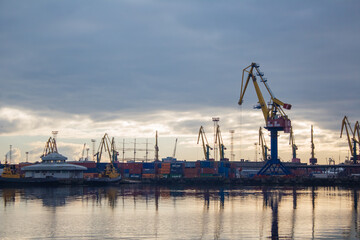 Fototapeta premium Lifting cranes and containers in the cargo port 