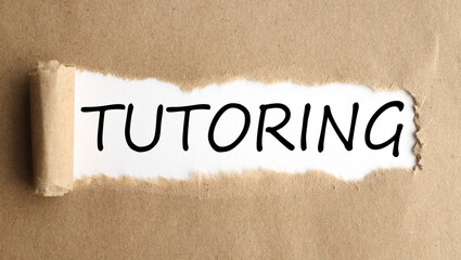 TUTORING, text on white paper on torn paper background.