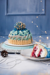 
Delicious and beautiful Christmas cake in the form of a knitted hat, sprinkled with powdered sugar. Vanilla biscuit with cranberry filling. New year cake