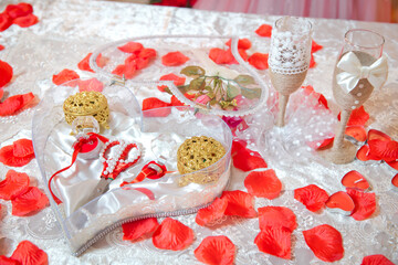 Scissors, ring containers. Artificial rose petals. Pearls . Engagement ring set .