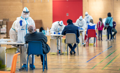Massive rapid COVID-19 testing for the  popolation. Health workers in protective suits are engaged...