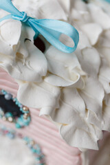 A beautiful colored gingerbread house decorated with glaze with caramel windows on a blue background. New Year's gift for children and the whole family