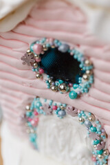 A beautiful colored gingerbread house decorated with glaze with caramel windows on a blue background. New Year's gift for children and the whole family