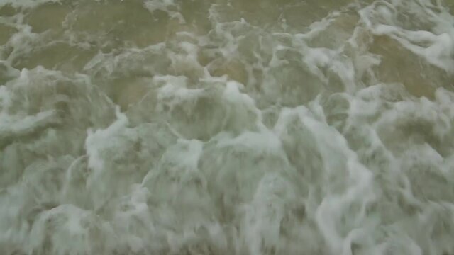 The waves of the sea hit the coast, hitting the sand.