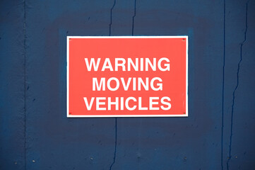 Warning moving vehicles sign at construction site 