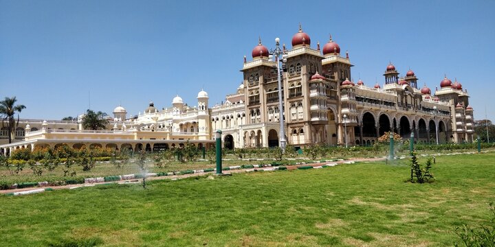 A photo of Mysore palace and its gardens during summer season.