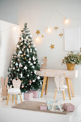 Cozy bright children's room with a Christmas tree, chair and toys in a light color