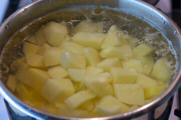 potatoes are cut into a saucepan and filled with water