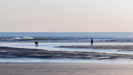 Fototapeta na wymiar two people on a beach in Devon