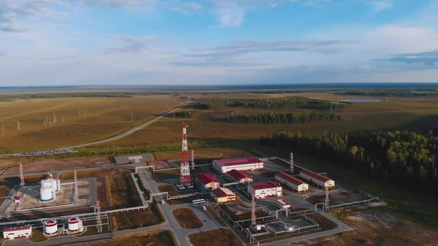 Deep in the taiga, there are oil-producing industrial buildings. Siberian swamps. bird's eye view