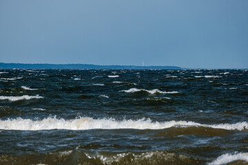 sea beach with white sand and blue water before storm