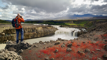 Landscape Photographer Capturing an Image of Thjofafoss Waterfall with Hekla Volcano on Top, Iceland © peresanz