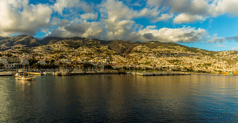 Cumulus clouds gather over Funchal, Madeira in the early evening sunshine