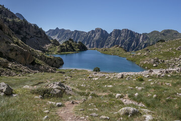 On the shore of  Cap de Port lake, after the descent from from Port de Rius mountain pass, on trail GR11.18 to Restanca refuge, Aiguestortes & Estany de Sant Maurici National Park, Pyrenees, Spain.