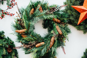Advent wreath, сonifer branches with pine cones and a red Christmas star on white background