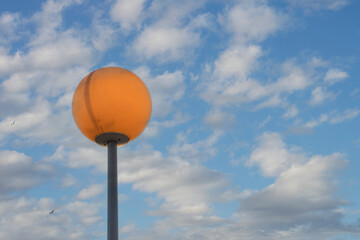 round lamppost isolated and cropped over sky with clouds