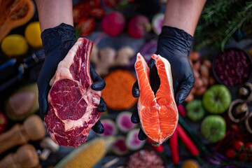 A chef is showing the meat kinds to the customer at the restaurant.
