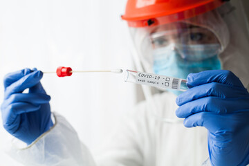 Physician wearing personal protective equipment performing a Coronavirus COVID-19 PCR test, patient nasal NP and oral OP swab sample specimen collection process, viral rt-PCR DNA diagnostic procedure - obrazy, fototapety, plakaty