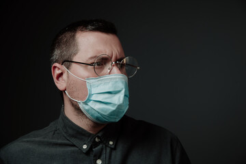 a man in a medical mask and glasses