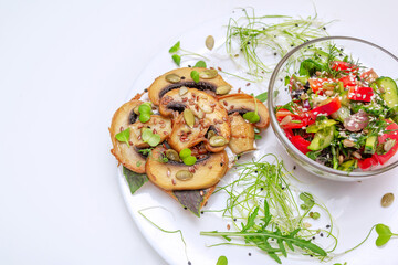 Sandwich with fried mushrooms, basil, pumpkin seeds and microgreens - radish and onion seedlings and tomato and cucumber salad, served with sesame seeds.