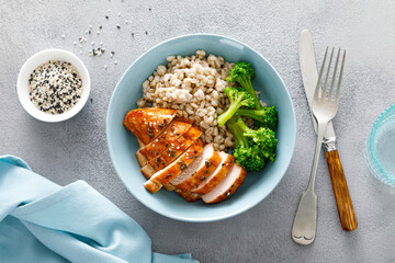 Baked chicken breast lunch bowl with pearl barley and broccoli