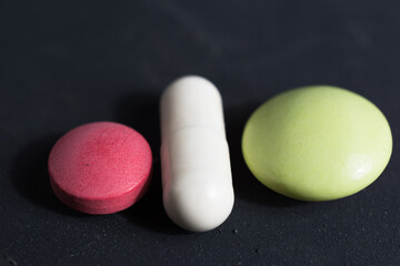 Different pills on the table in close-up.